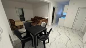 a living room with a table and chairs at Sabo Villa in Pečurice