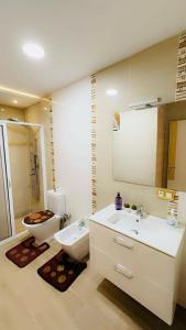 a bathroom with a sink and a toilet and a mirror at Luxury in Tétouan