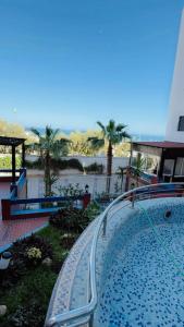 a swimming pool with a track next to a body of water at Luxury in Tétouan