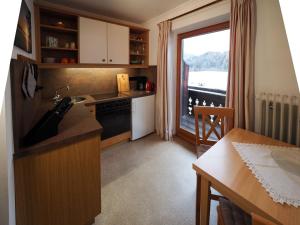 a kitchen with a sink and a table and a window at Beim Lenz in Schleching
