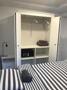 a bedroom with a bed with a black and white stripes at Bella Vista apartment 2 in Izola