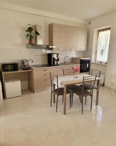 a kitchen with a table and chairs in a room at ALBACHIARA in Ramazzano +8 photos