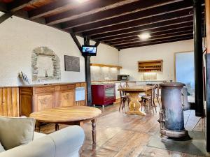 a living room with a table and a kitchen at chez Fred in Saint-Rambert-en-Bugey