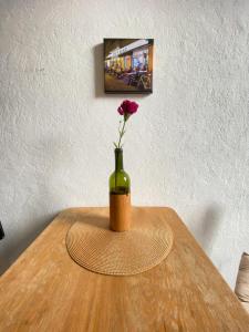a vase with a rose in it sitting on a table at Berlin-Neukölln Realness in Berlin