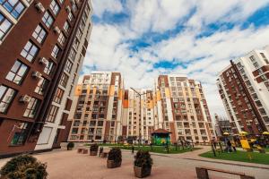 a group of tall buildings in a city at Decebal Apartment in Chişinău