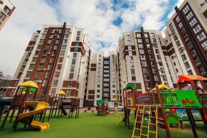 a playground in front of some tall buildings at Decebal Apartment in Chişinău