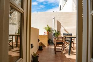 a view of a balcony with a table and chairs at SUITE HOUSE THISSION in Athens