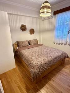 a bedroom with a bed and a chandelier at Central House in Plaka in Athens