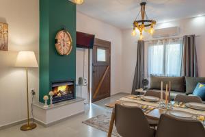 a living room with a table and a fireplace at Kostis Orange Resort in Volos