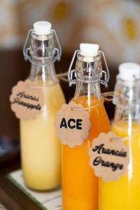 a group of three bottles of orange juice on a table at Villa il Turro in Massa Lubrense