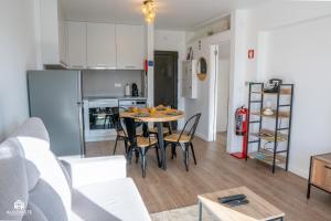 a kitchen and a living room with a table and chairs at Casa do Parque - Santa Cruz in Santa Cruz +30 photos