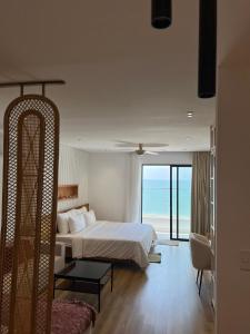 a bedroom with a bed and a view of the ocean at Căn Hộ TMS View Biển Quy Nhơn in Quy Nhon