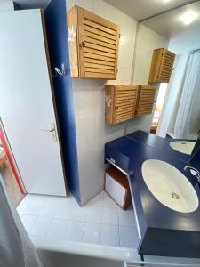 a bathroom with a blue counter and a sink at F2 front de neige la Rosière in La Rosière