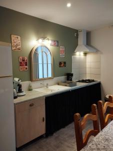 a kitchen with a sink and a counter top at Gîte proche du canal du midi et Narbonne 2 chambres in Mirepeisset