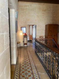 a hallway with a staircase in a stone building at Xemx in Qala