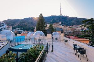 a balcony with glass domes and a swimming pool at Magnolia in Tbilisi City