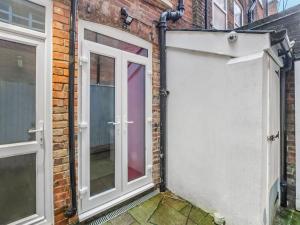 a door to a garage in a brick building at Snap Pad - Uk46421 in Royal Tunbridge Wells