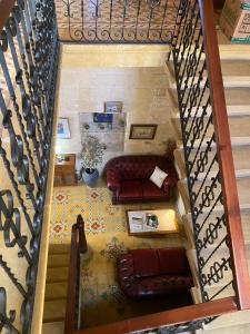 a view of a living room with a couch and stairs at Xemx in Qala