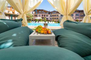a bowl of fruit sitting on a table with pillows at Green Wood Hotel & Spa Bansko in Bansko
