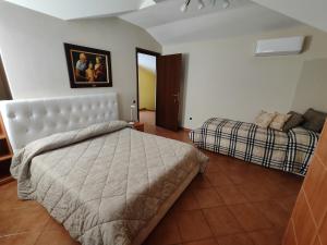 a bedroom with a bed and a couch in it at B&B Rossella in Montoro Inferiore