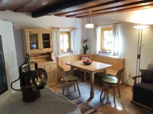 a living room with a table and a kitchen at Chalet Ramsau 8 in Bad Goisern