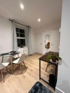 a living room with a glass table and chairs at Cosy Maidstone Flat near Station (Town Centre) in Kent