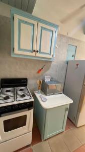a kitchen with a stove and a refrigerator at Caribbean Paradise steps to DayPass Resort&Beach in La Laguna