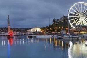 a ferris wheel and a ferris wheel in a harbor at Torquay in Torquay