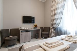 a hotel room with a bed with towels on it at Brera Prestige B&B in Milan