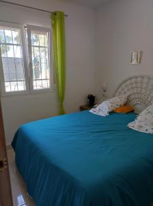 a bedroom with a blue bed with two pillows at Villa stamalmar in Villaricos +21 photos