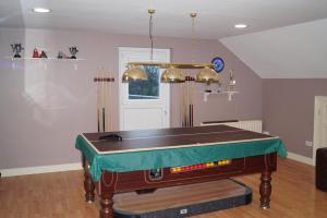 a ping pong table in a living room with at Clonmurr B&B in Ballyroney