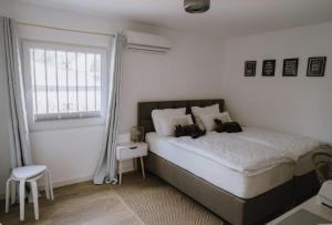 a bedroom with a bed with two dogs on it at Oliveres3 in L'Ampolla