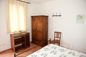 a bedroom with a bed and a wooden cabinet at La Nostra Maremma in Marsiliana +36 photos