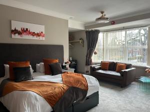 a bedroom with a large bed and a couch at Ashbourne House in York