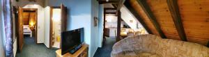 a living room with a couch and a tv in a house at Ferienwohnungen Christel in Wernigerode