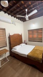 a bedroom with a large bed and a window at Happy Land in Shoranūr