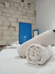 a rolled up towel sitting on top of a bed at Limestone Sun Suites in Sliema