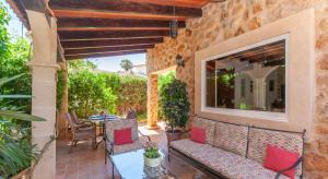 een patio met rode kussens en een tafel en stoelen bij Casa Piedra Mallorca in El Toro