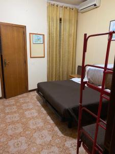 a bedroom with a bunk bed and a door at Nuovo Hotel Attico in Chianciano Terme