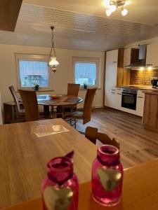 a kitchen and living room with a table and chairs at Zum Bergschlösschen in Gilserberg