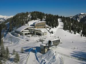 a ski lodge on a snow covered ski slope at Nevi Apartment in Folgarida