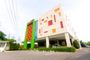 a large building with colorful squares on the side of it at Front One Hotel Purwodadi in Purwodadi