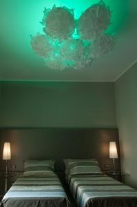 a room with two beds and two lamps in it at Brera Prestige B&B in Milan