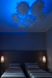 a hotel room with two beds and two lights at Brera Prestige B&B in Milan
