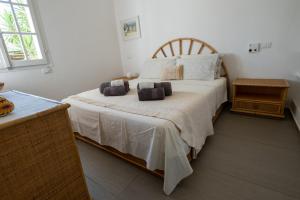 a bedroom with a bed with two pillows on it at Villa Claudia Torre Delle Stelle in Torre delle Stelle
