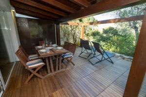 a wooden deck with a table and chairs on it at Villa Claudia Torre Delle Stelle in Torre delle Stelle