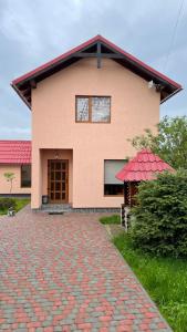 a house with a brick walkway in front of it at Azaliya in Lazeshchyna