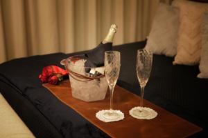 a table with two wine glasses and a bottle on it at Itaim Bibi - The Capital Flat - Apto 1211 in São Paulo