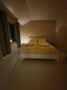 a bed in a small room with a window at Arctic Cabin Lyngen in Svensby