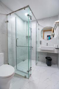a bathroom with a glass shower and a toilet at Căn Hộ TMS View Biển Quy Nhơn in Quy Nhon